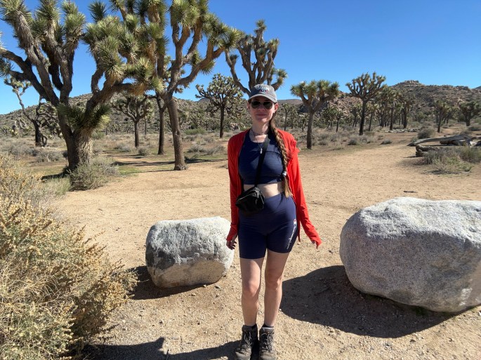 A woman standing among the Joshua Trees at Joshua Tree National Park during the shutdown